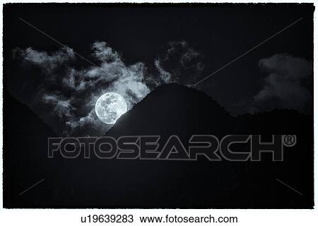 Machu Picchu full moon rising behind mountain silhouette with dramatic clouds, Machu Picchu, Sacred Valley, Peru View Large Photo Image Stock Image - Machu Picchu full moon rising behind mountain silhouette with dramatic clouds, Machu Picchu, Sacred Valley, Peru. Fotosearch