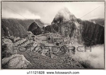 Machu Picchu Inca ruins: monochrome view of entire complex: Eastern Urban sector, Royal Palaces and Temple of the Sun, Intihuatana, with Huayna Picchu beyond, in early morning mist, Machu Picchu, Sacred Valley, Peru View Large Photo Image Stock Photo - Machu Picchu Inca ruins: monochrome view of entire complex: Eastern Urban sector, Royal Palaces and Temple of the Sun, Intihuatana, with Huayna Picchu beyond, in early morning mist, Machu Picchu, Sacred Valley, Peru. Fotosearch