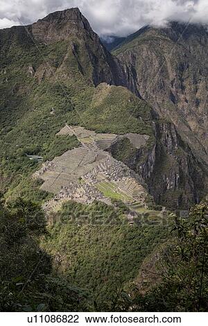 Machu Picchu Inca ruins: view of entire complex and Machu Picchu mountain, as seen from Huayna Picchu mountain, morning sunlight after storm, Machu Picchu, Sacred Valley, Peru View Large Photo Image Stock Image - Machu Picchu Inca ruins: view of entire complex and Machu Picchu mountain, as seen from Huayna Picchu mountain, morning sunlight after storm, Machu Picchu, Sacred Valley, Peru. Fotosearch