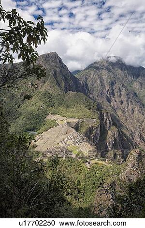 Machu Picchu Inca ruins: view of entire complex and Machu Picchu mountain, as seen from Huayna Picchu mountain, morning sunlight after storm, Machu Picchu, Sacred Valley, Peru View Large Photo Image Stock Image - Machu Picchu Inca ruins: view of entire complex and Machu Picchu mountain, as seen from Huayna Picchu mountain, morning sunlight after storm, Machu Picchu, Sacred Valley, Peru. Fotosearch