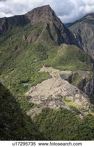 Stock Photography - Machu Picchu Inca ruins: view of entire complex and Machu Picchu mountain, as seen from Huayna Picchu mountain, morning sunlight after storm, Machu Picchu, Sacred Valley, Peru. Fotosearch
