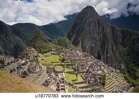 Machu Picchu Inca ruins: view of Eastern Urban sector and Royal Palaces and Temple of the Sun, with Huayna Picchu beyond, as seen from Sun Gate trail afternoon sunlight after storm, Machu Picchu, Sacred Valley, Peru View Large Photo Image Stock Image - Machu Picchu Inca ruins: view of Eastern Urban sector and Royal Palaces and Temple of the Sun, with Huayna Picchu beyond, as seen from Sun Gate trail afternoon sunlight after storm, Machu Picchu, Sacred Valley, Peru. Fotosearch