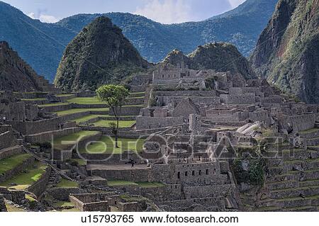 Stock Photography - Machu Picchu Inca ruins: view of Eastern Urban sector in evening sunlight after storm, Machu Picchu, Sacred Valley, Peru. Fotosearch