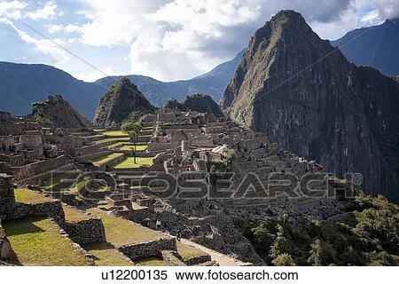 Stock Photography - Machu Picchu: view of Inca ruins with Huayna Picchu mountain in evening sunlight after storm, Machu Picchu, Sacred Valley, Peru. Fotosearch
