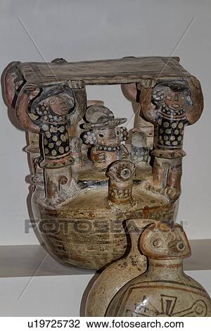 Stock Image - Museo Larco: closeup of two ornately patterned ceramic Moche drinking vessels, with human figures, Lima, Peru. Fotosearch