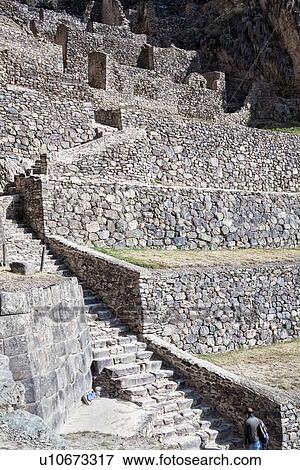 Ollantaytambo: detail of stone stairway and agricultural terracing of Inca citadel with single tourist at bottom,, Ollantaytambo, Sacred Valley, Cuzco, Peru View Large Photo Image Stock Photo - Ollantaytambo: detail of stone stairway and agricultural terracing of Inca citadel with single tourist at bottom,, Ollantaytambo, Sacred Valley, Cuzco, Peru. Fotosearch