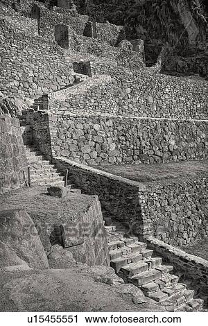 Stock Image - Ollantaytambo: monochrome detail of stone stairway and agricultural terracing of Inca citadel, Ollantaytambo, Sacred Valley, Cuzco, Peru. Fotosearch