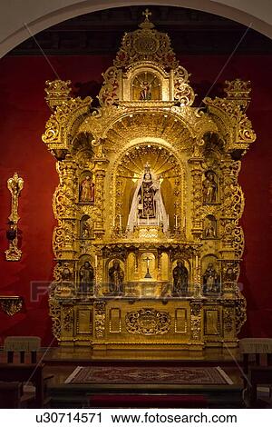Stock Image - Ornate gold altar piece with saints and Madonna, Spanish Baroque, Archbishop's palace, Lima, Peru. Fotosearch