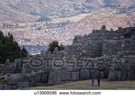 Sacsaywaman Inca ruins: view of the massive zig zag stone wall fortifications in late afternoon sunlight with tourist in foreground, Sacred Valley, Cuzco, Peru View Large Photo Image Stock Photograph - Sacsaywaman Inca ruins: view of the massive zig zag stone wall fortifications in late afternoon sunlight with tourist in foreground, Sacred Valley, Cuzco, Peru. Fotosearch