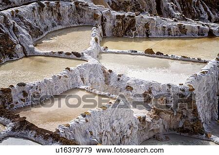 Stock Photo - Salinas salt pans, aerial view detail of terraced rectangular pans filled with concentrated saline to evaporate, Sacred Valley, Peru. Fotosearch