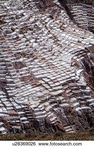 Stock Photograph - Salinas salt pans, aerial view detail of terraced rectangular pans filled with concentrated saline to evaporate, Sacred Valley, Peru. Fotosearch