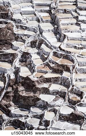 Stock Photography - Salinas salt pans, aerial view detail of terraced rectangular pans filled with concentrated saline to evaporate, Sacred Valley, Peru. Fotosearch