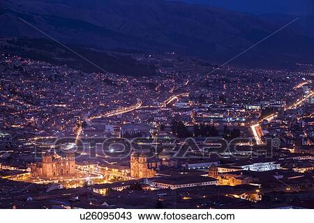 Twilight view of Cuzco night lights: Plaza de Armas with Iglesia de la Compania on right,, and Catedral to left, as seen across red tiled rooftops from Pukin, mountains beyond, Cuzco, Peru View Large Photo Image Stock Image - Twilight view of Cuzco night lights: Plaza de Armas with Iglesia de la Compania on right,, and Catedral to left, as seen across red tiled rooftops from Pukin, mountains beyond, Cuzco, Peru. Fotosearch