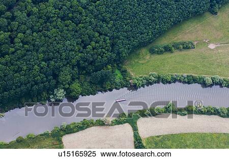 Stock Photography - Aerial view of boat in rural river. Fotosearch