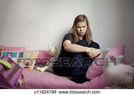 Annoyed preteen girl surrounded by toys View Large Photo Image Stock Photo - Annoyed preteen girl surrounded by toys. Fotosearch