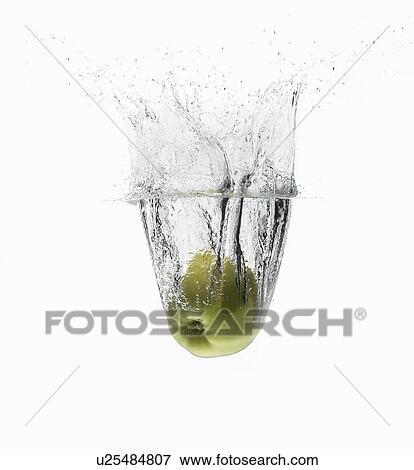 Apple splashing in water View Large Photo Image Stock Photo - Apple splashing in water. Fotosearch