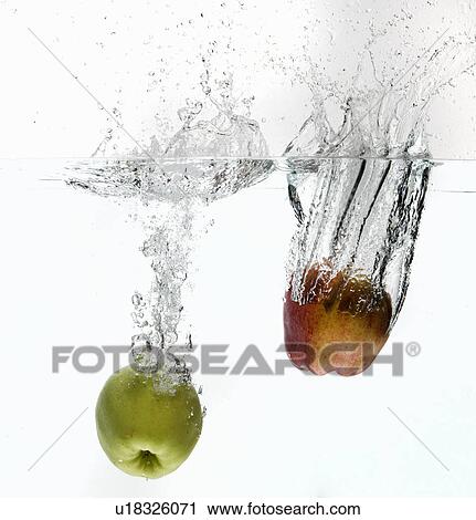 Stock Image - Apples splashing in water. Fotosearch