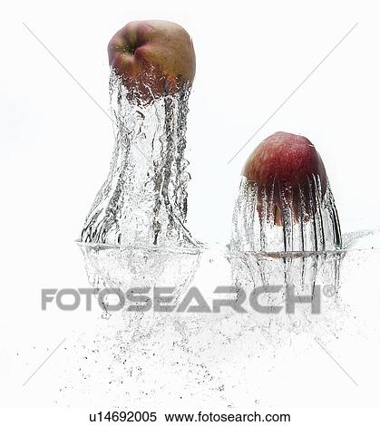 Apples splashing in water View Large Photo Image Stock Photography - Apples splashing in water. Fotosearch