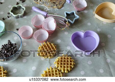 Stock Image - Baking implements in messy kitchen. Fotosearch