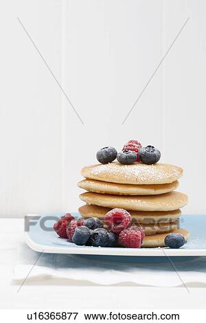 Berries and sugar on stack of pancakes View Large Photo Image Stock Photo - Berries and sugar on stack of pancakes. Fotosearch