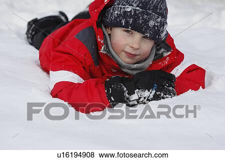 Boy in parka playing in snow View Large Photo Image Stock Photo - Boy in parka playing in snow. Fotosearch