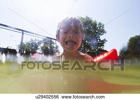 Boy in swimming pool sticking out tongue View Large Photo Image Stock Photograph - Boy in swimming pool sticking out tongue. Fotosearch