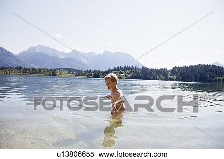 Stock Photography - Boy swimming in lake. Fotosearch