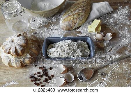 Stock Image - Bread loaves and dough in messy kitchen. Fotosearch