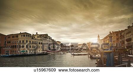 Stock Photo - Buildings and boats on urban canal. Fotosearch