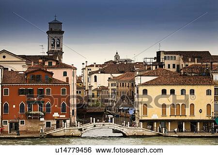 Stock Photograph - Buildings and bridge on urban canal. Fotosearch