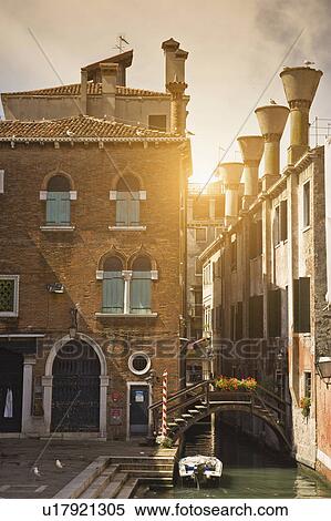 Stock Photography - Buildings and bridge on urban canal. Fotosearch