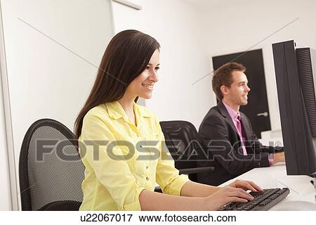 Stock Photo - Business people at work in office. Fotosearch