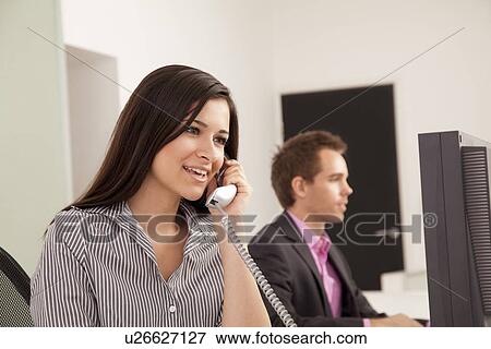 Stock Photo - Business people at work in office. Fotosearch