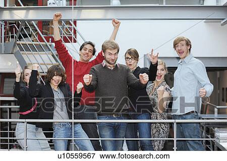 Business people cheering in office View Large Photo Image Stock Photo - Business people cheering in office. Fotosearch