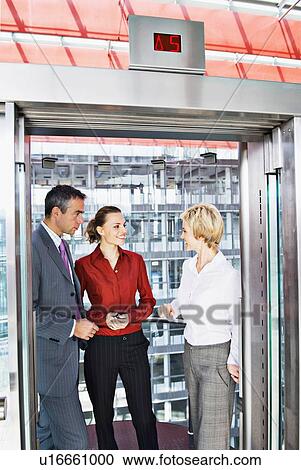 Business people riding elevator View Large Photo Image Stock Image - Business people riding elevator. Fotosearch