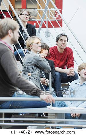 Stock Photo - Business people sitting in office. Fotosearch
