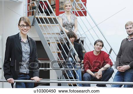 Business people standing in office View Large Photo Image Stock Image - Business people standing in office. Fotosearch