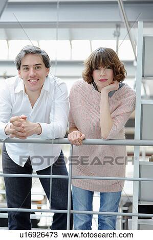 Business people standing in office View Large Photo Image Stock Image - Business people standing in office. Fotosearch