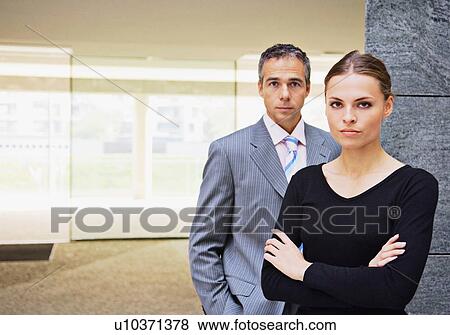 Business people standing in office View Large Photo Image Stock Photo - Business people standing in office. Fotosearch