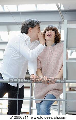 Business people whispering in office View Large Photo Image Stock Image - Business people whispering in office. Fotosearch