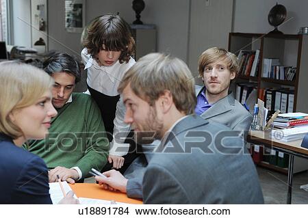 Business people working together at desk View Large Photo Image Picture - Business people working together at desk. Fotosearch