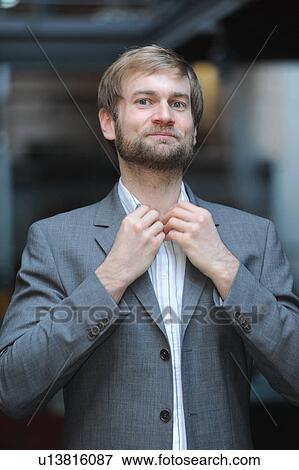 Stock Photo - Businessman adjusting his collar. Fotosearch