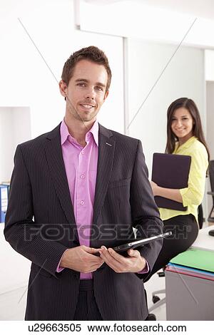 Businessman carrying tablet computer View Large Photo Image Stock Photography - Businessman carrying tablet computer. Fotosearch
