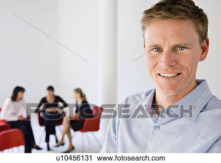 Businessman smiling in office View Large Photo Image Stock Image - Businessman smiling in office. Fotosearch