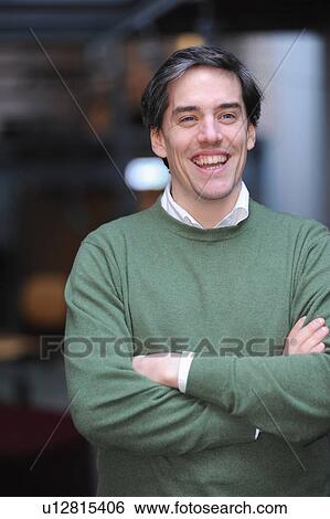 Stock Photograph - Businessman standing with arms folded. Fotosearch