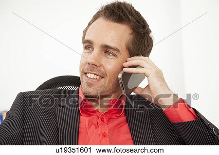 Businessman talking on cell phone View Large Photo Image Stock Image - Businessman talking on cell phone. Fotosearch