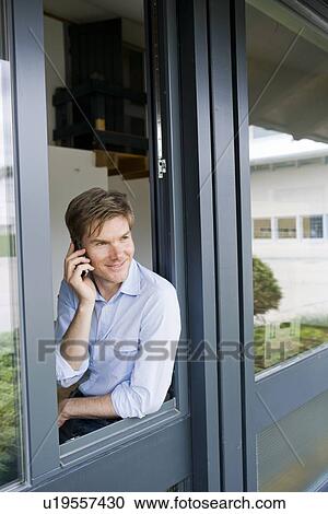 Businessman talking on cell phone View Large Photo Image Stock Image - Businessman talking on cell phone. Fotosearch