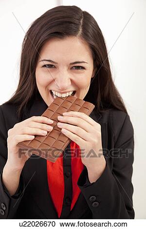 Businesswoman eating bar of chocolate View Large Photo Image Stock Image - Businesswoman eating bar of chocolate. Fotosearch