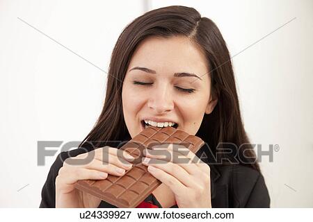 Businesswoman eating bar of chocolate View Large Photo Image Stock Photo - Businesswoman eating bar of chocolate. Fotosearch