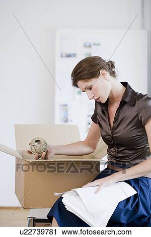 Businesswoman reading papers in office View Large Photo Image Stock Image - Businesswoman reading papers in office. Fotosearch